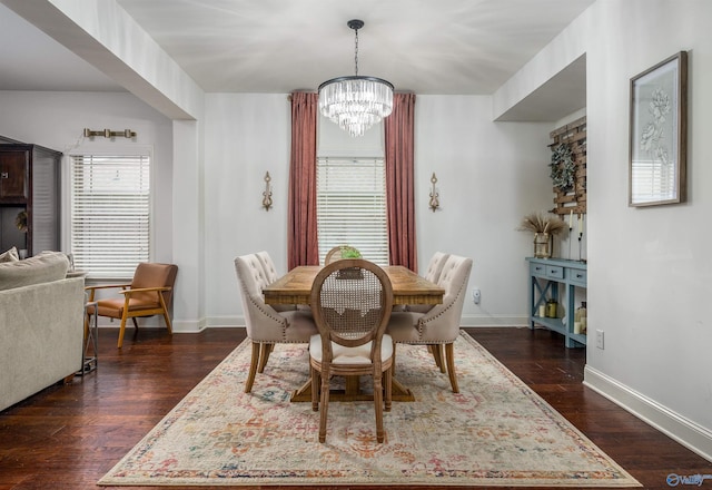 dining room with dark wood-type flooring, a chandelier, and baseboards