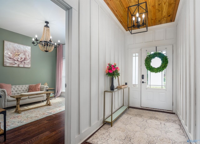 entryway featuring wood finished floors, wood ceiling, and an inviting chandelier