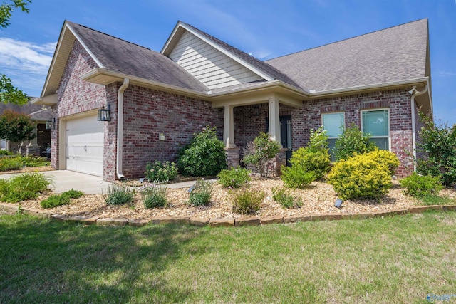 view of front facade featuring a front yard, brick siding, an attached garage, and roof with shingles