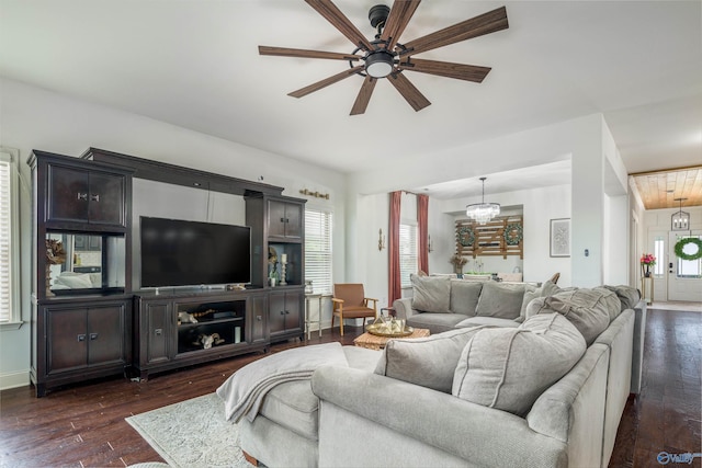 living room with dark wood-style flooring and ceiling fan with notable chandelier