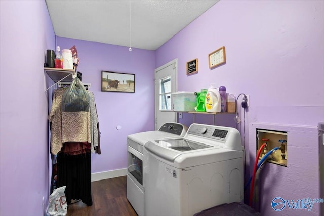 laundry area featuring a textured ceiling, washer and dryer, and dark wood-type flooring