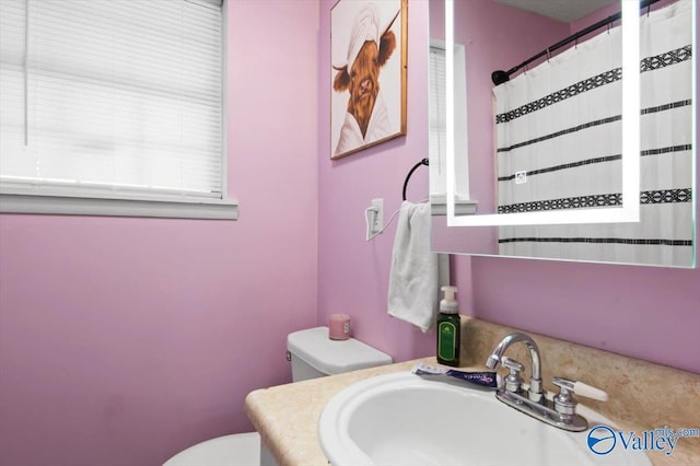 bathroom featuring vanity and toilet