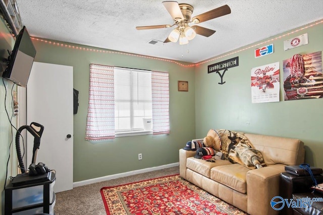 living room featuring carpet, a textured ceiling, and ceiling fan