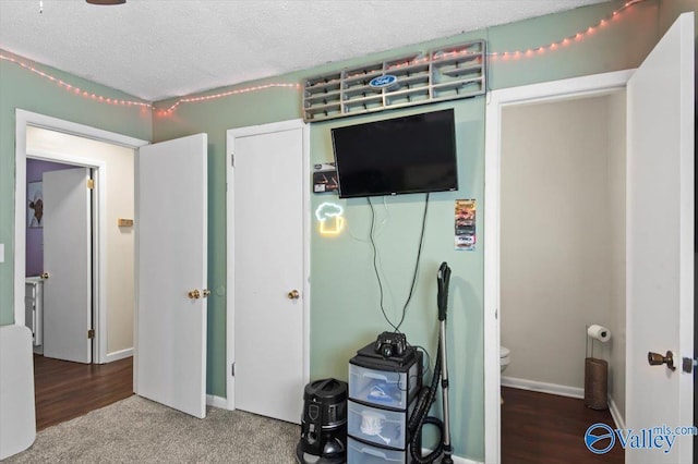 bedroom featuring carpet floors and a textured ceiling