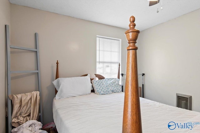 bedroom featuring a textured ceiling and ceiling fan