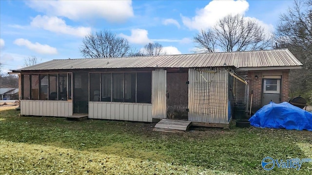 rear view of property with a lawn