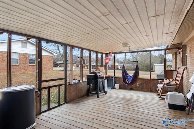 unfurnished sunroom with wood ceiling