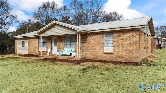 ranch-style home with covered porch and a front lawn