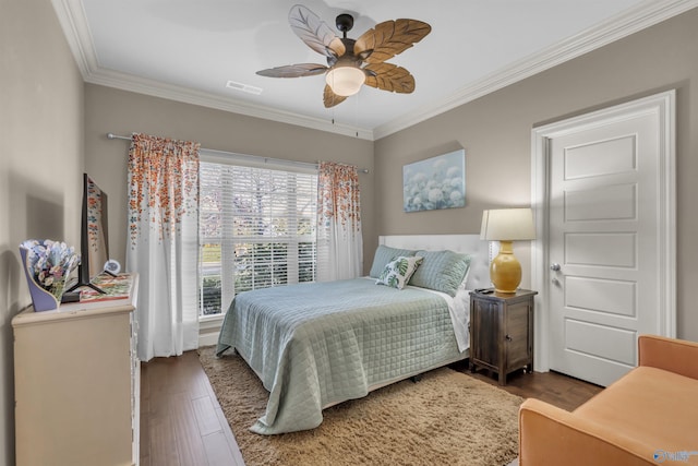 bedroom featuring wood-type flooring, ceiling fan, and crown molding