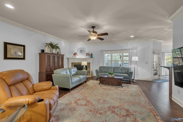 living room featuring ornamental molding, plenty of natural light, ceiling fan, and dark hardwood / wood-style flooring