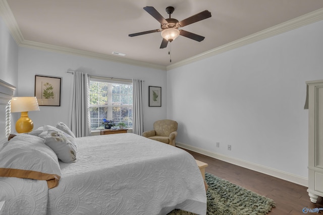 bedroom with ornamental molding, ceiling fan, and dark hardwood / wood-style floors