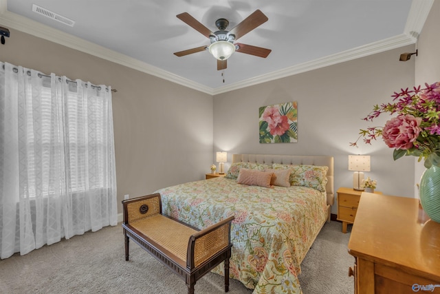 carpeted bedroom with ceiling fan and crown molding