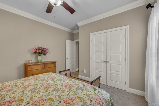 bedroom with ceiling fan, light carpet, a closet, and crown molding