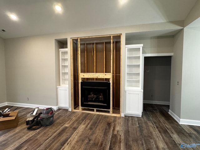 unfurnished living room with dark hardwood / wood-style flooring