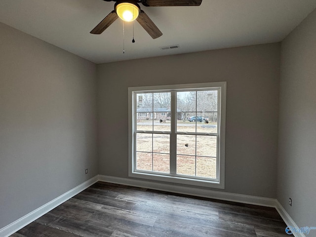 spare room featuring ceiling fan and dark wood-type flooring