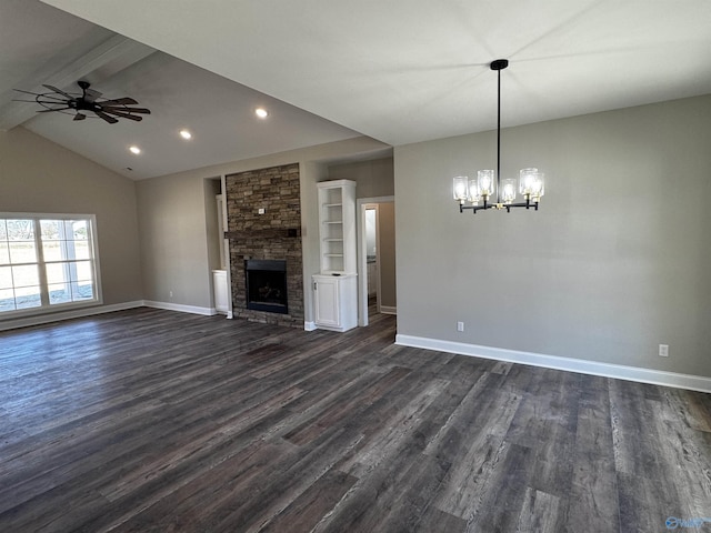 unfurnished living room with ceiling fan with notable chandelier, a stone fireplace, dark wood-type flooring, and lofted ceiling