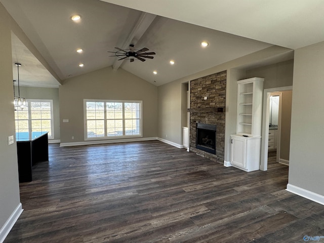 unfurnished living room featuring a fireplace, ceiling fan, vaulted ceiling with beams, and dark hardwood / wood-style floors