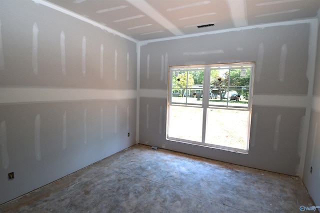 empty room with concrete flooring