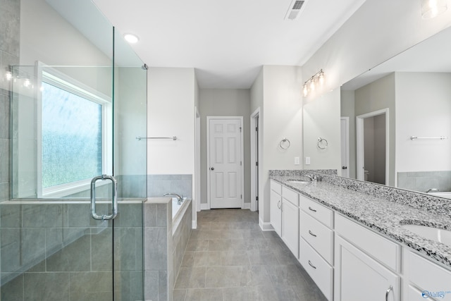 bathroom with vanity, independent shower and bath, and tile patterned flooring