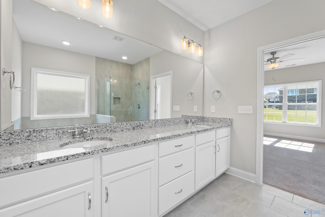 bathroom with vanity, walk in shower, ceiling fan, and tile patterned flooring