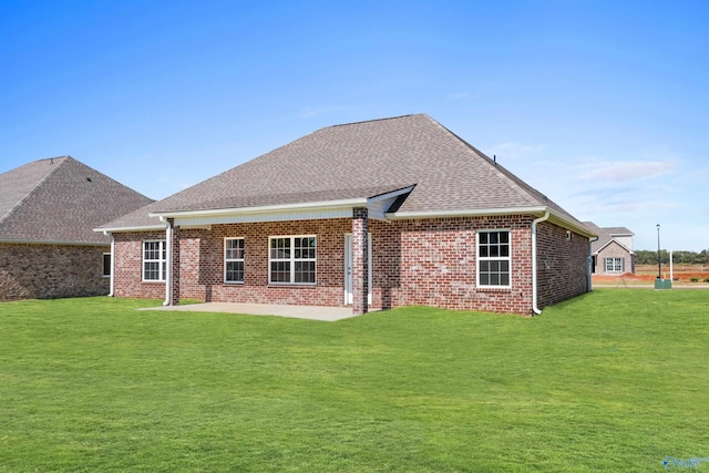 back of property with a patio and a lawn