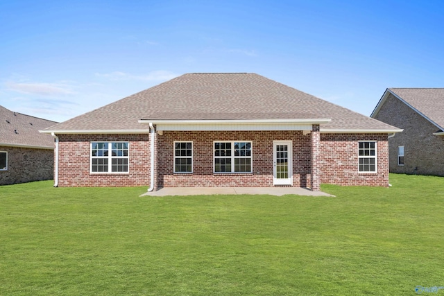 back of property with a yard and a patio area