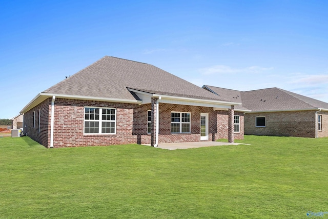 back of property featuring a yard and a patio