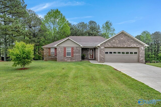 ranch-style house featuring brick siding, an attached garage, a front lawn, and concrete driveway