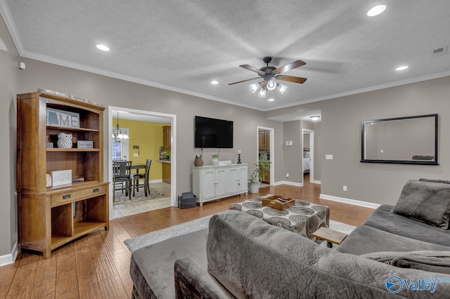 living room featuring hardwood / wood-style floors, ceiling fan with notable chandelier, and recessed lighting