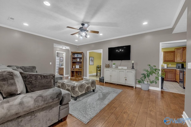 living area featuring baseboards, recessed lighting, a ceiling fan, light wood-style floors, and visible vents