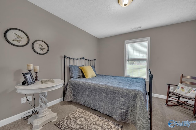 bedroom featuring carpet, visible vents, baseboards, and a textured ceiling