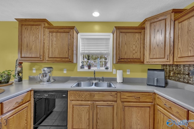 kitchen with brown cabinetry, dishwasher, light countertops, and a sink