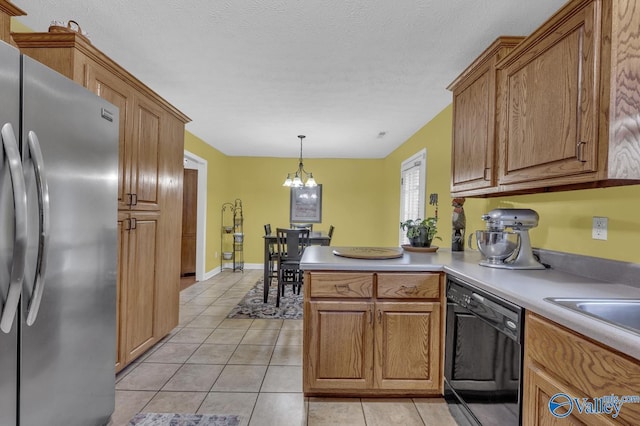 kitchen with light tile patterned floors, a notable chandelier, freestanding refrigerator, and black dishwasher