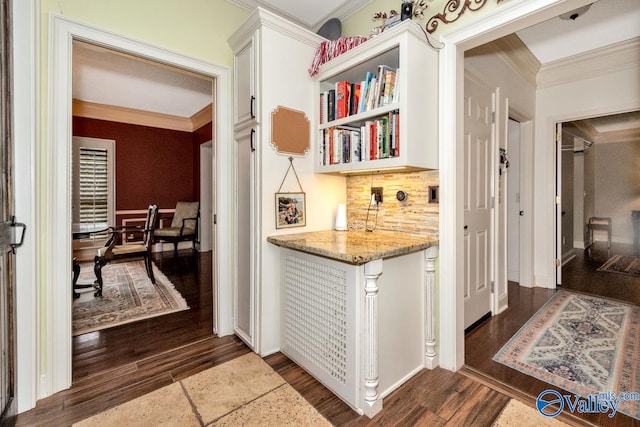 hall with ornamental molding and dark hardwood / wood-style flooring