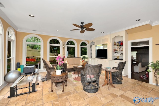 interior space featuring crown molding, built in shelves, and ceiling fan