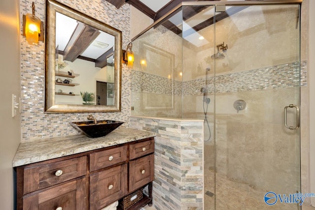 bathroom with backsplash, beamed ceiling, a shower with door, and vanity