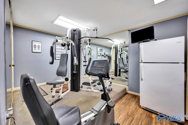 workout room featuring light wood-type flooring