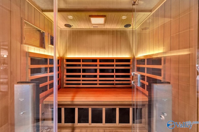 view of sauna with wood-type flooring, wood ceiling, and wooden walls