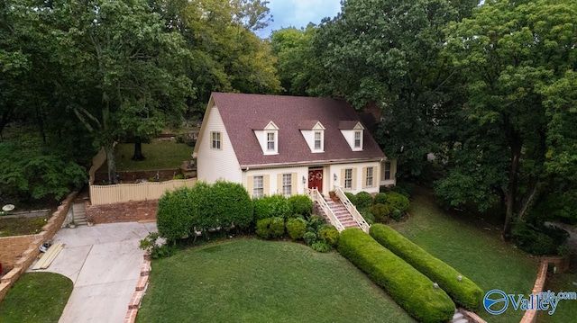 new england style home with a front lawn