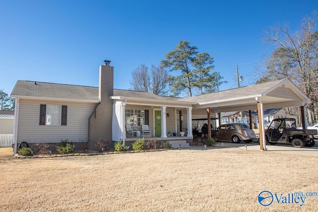 single story home with a porch, a front lawn, and a carport