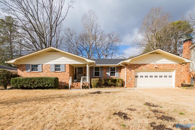 ranch-style home with a garage and covered porch