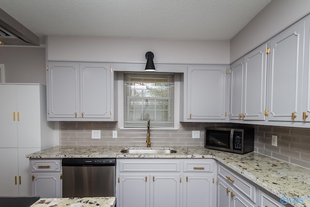 kitchen featuring stainless steel appliances, white cabinetry, sink, and a textured ceiling