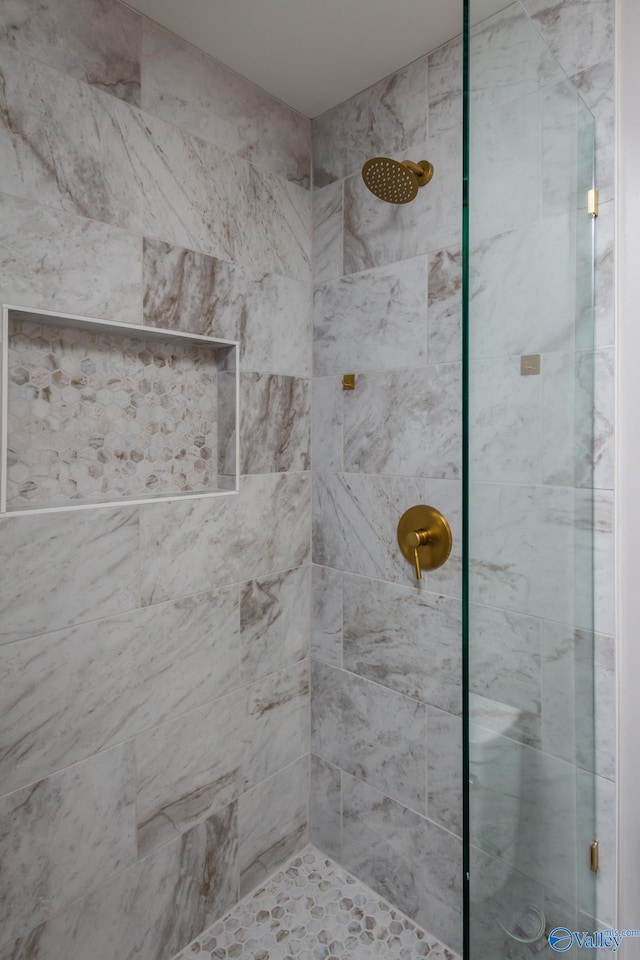 bathroom with tiled shower