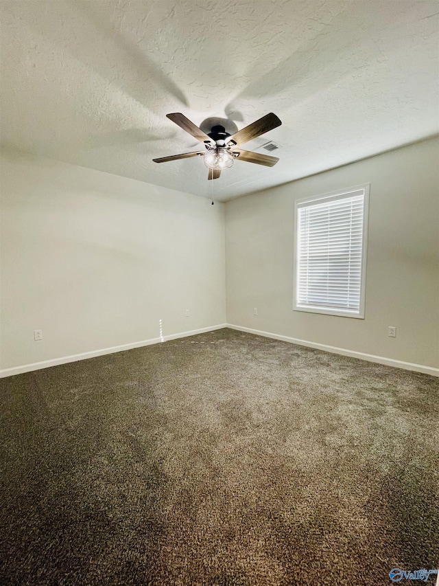 carpeted spare room featuring a textured ceiling and ceiling fan