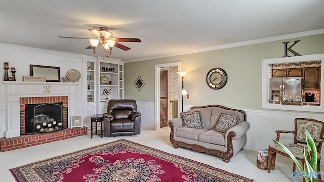 carpeted living room featuring a brick fireplace, ornamental molding, a textured ceiling, and ceiling fan