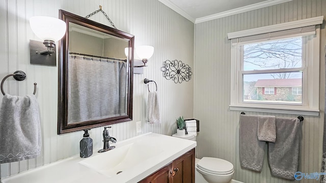 bathroom featuring crown molding, vanity, and toilet