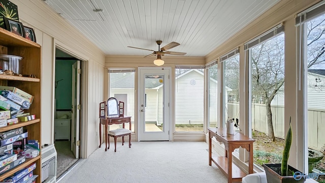 sunroom / solarium with wood ceiling and ceiling fan