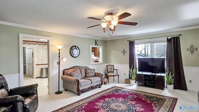 carpeted living room with crown molding, ceiling fan, and a textured ceiling