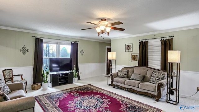 living room with crown molding, ceiling fan, and light carpet