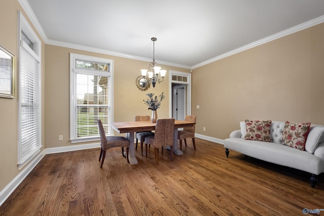 dining space featuring a chandelier, dark wood-style flooring, crown molding, and baseboards